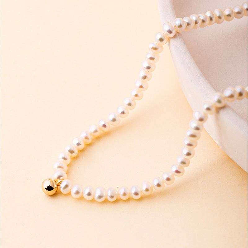 Collar Nikki de oro macizo de 18 quilates con auténtica perla de agua dulce